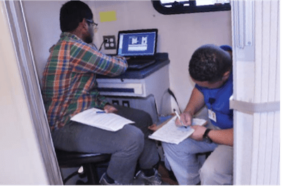 Mobile Medical Unit Patient Filling Out Paperwork