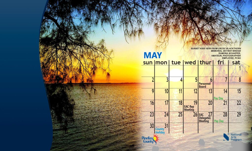 sample of desktop calendar image with a silhouetted tree over water at sunset and May 2021 calendar superimposed over the scene