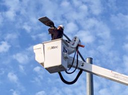 A man maintains one of Pinellas County's LED streetlights using a bucket truck