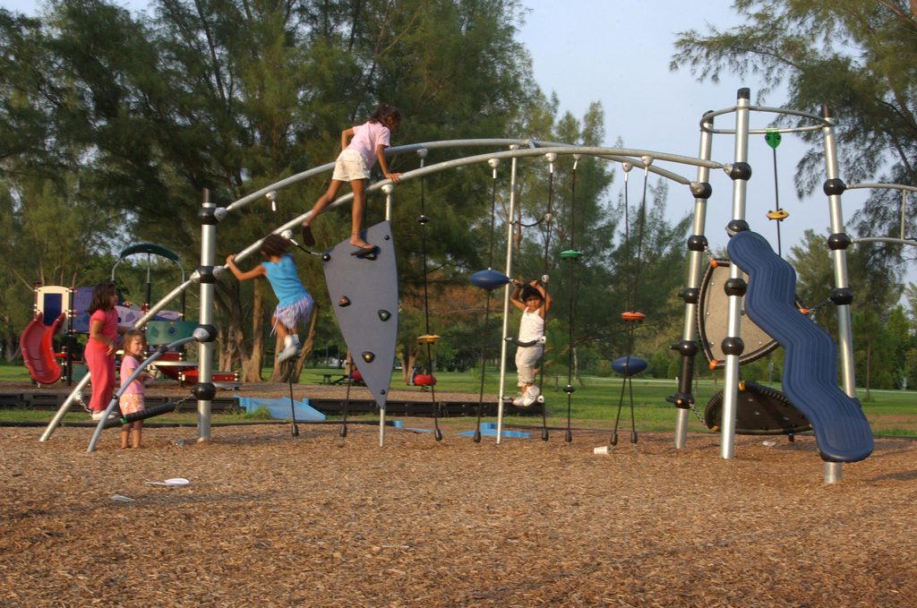 Kids playing on an amazing playground at Sand Key Park