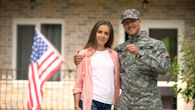 Soldier and wife showing keys from new house.
