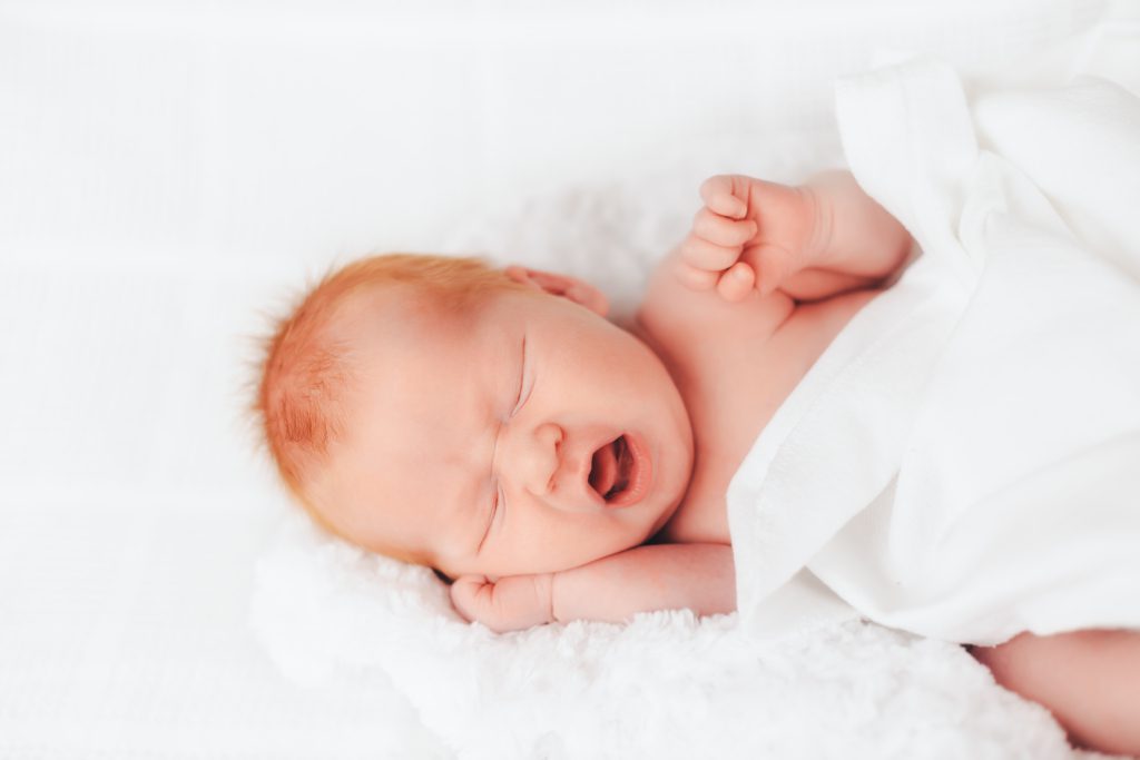 sleeping newborn baby yawns