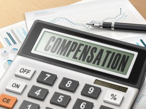 calculator with the word compensation on the display