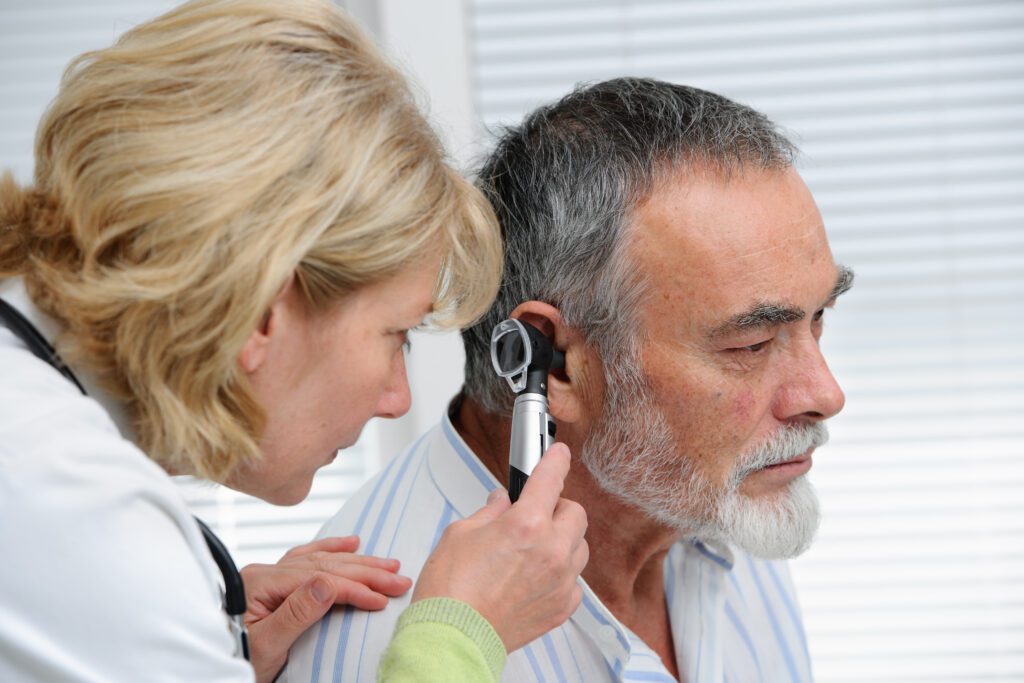 ENT physician looking into patient's ear with an instrument