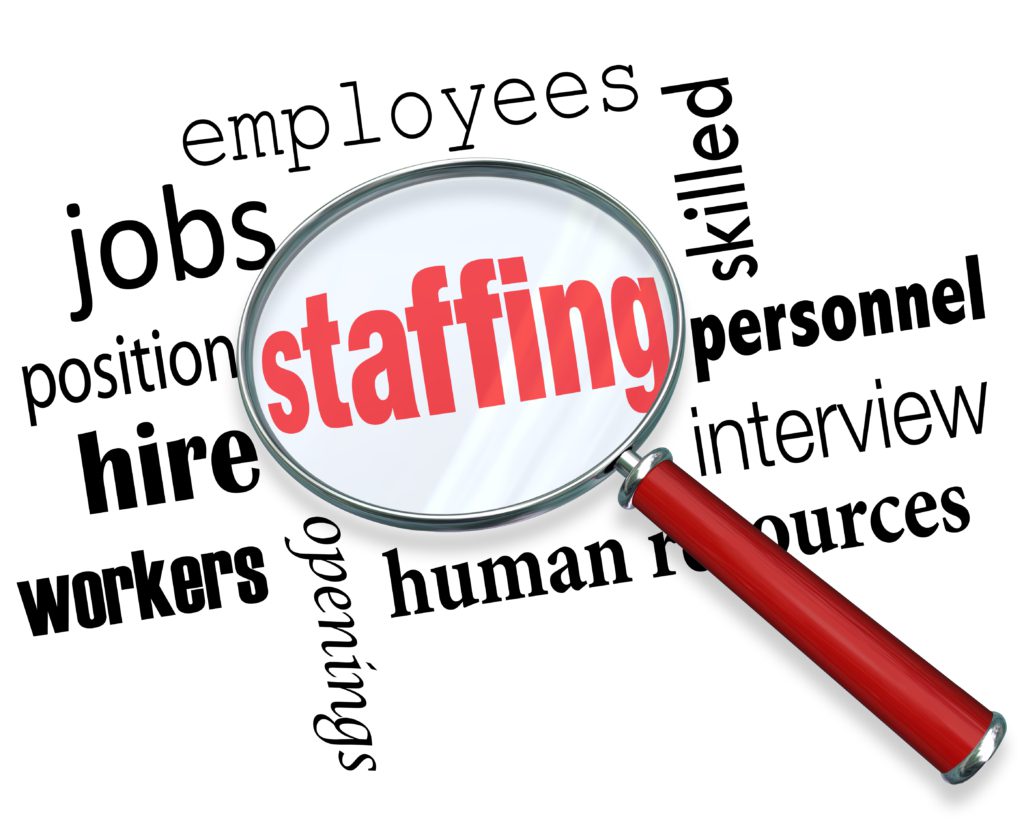 Staffing words under a magnifying glass with related terms like jobs, position, workers, employees, human resources and interview