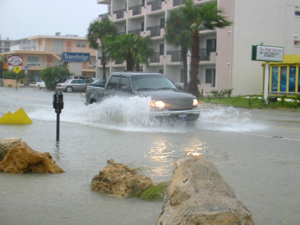 Car driving through flooded streets