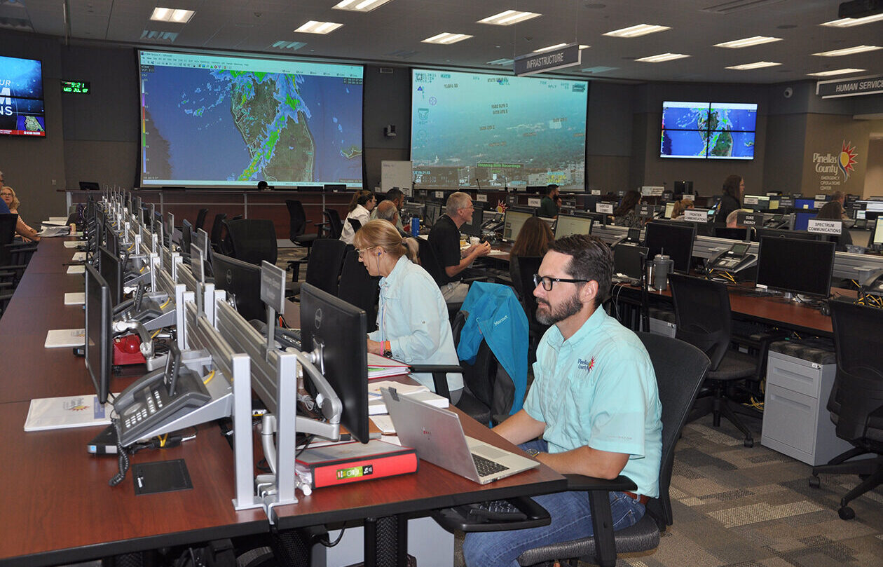Emergency Management staff members work on various computers in the Emergency Operations Center during an activation.