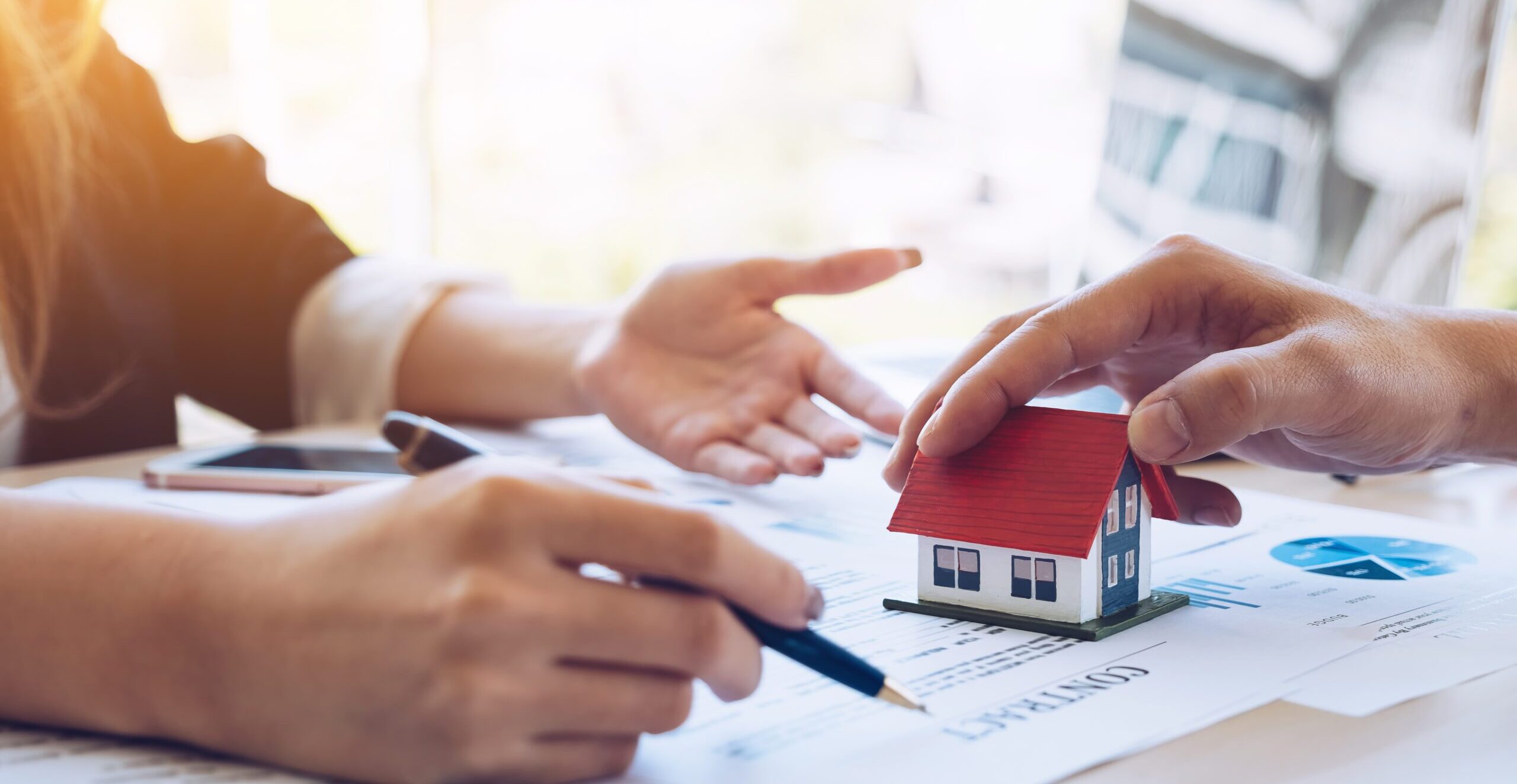 experienced real estate agent showing house model to client and ready to sign contract