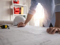 Architect working in office with blueprints,engineer thinking and planning inspection in workplace for architectural plan,sketching a construction project,Business construction concept.