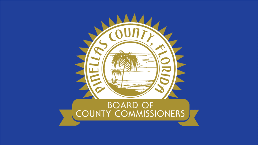 The gold Board of County Commissioners seal on a blue background