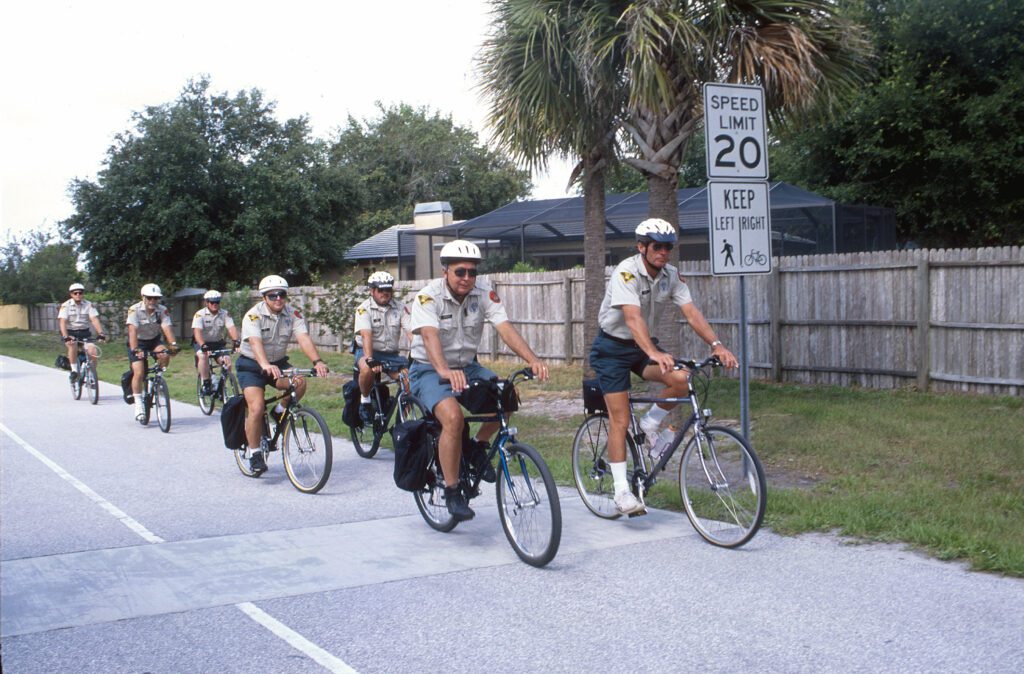 Auxillary rangers in uniform riding bikes on the Pinellas Trail
