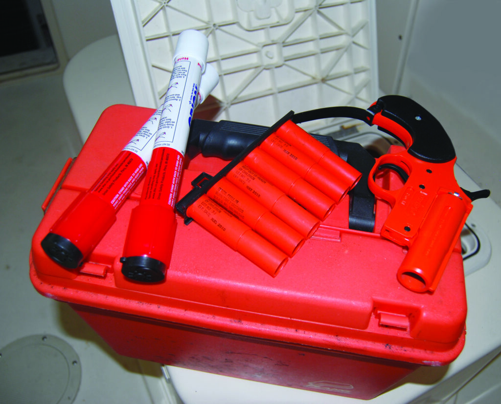 red flare kit with flare gun and plastic case
