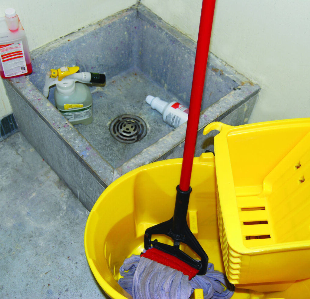 mop and bucket near an industrial sink