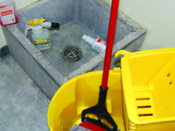 mop and bucket near an industrial sink