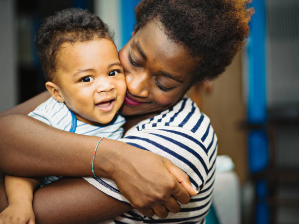 African mother with mixed race son at home