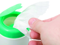 taking wipes from a dispenser isolated against white background