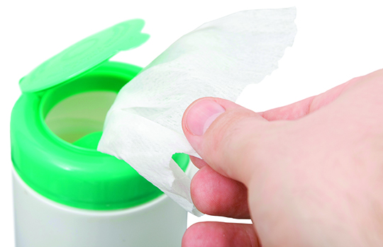 taking wipes from a dispenser isolated against white background