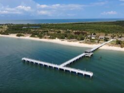 Aerial photograph of the T-shaped Fort De Soto Bay Pier looking from the south to the northwest.