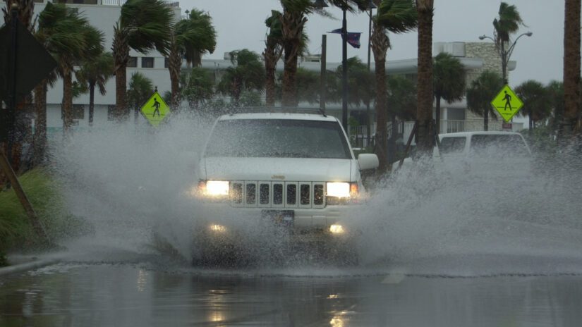 An SUV drives through flooded street in Pinellas County during storm.