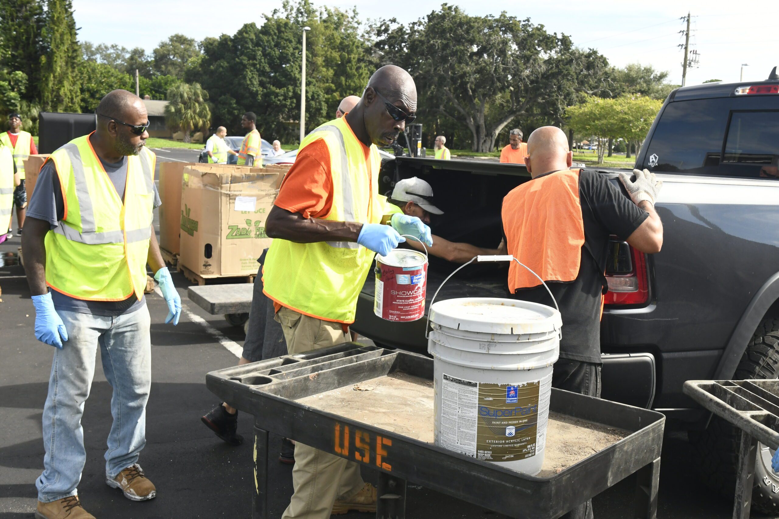 County workers collecting residents drive-thru chemicals from Solid Waste mobile collections event at St. Pete College