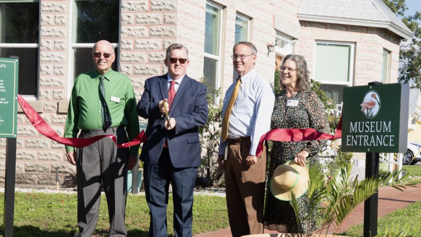 Commissioners Justice and Eggers join members of the Palm Harbor Museum in cutting ribbon to open living landscape gardens