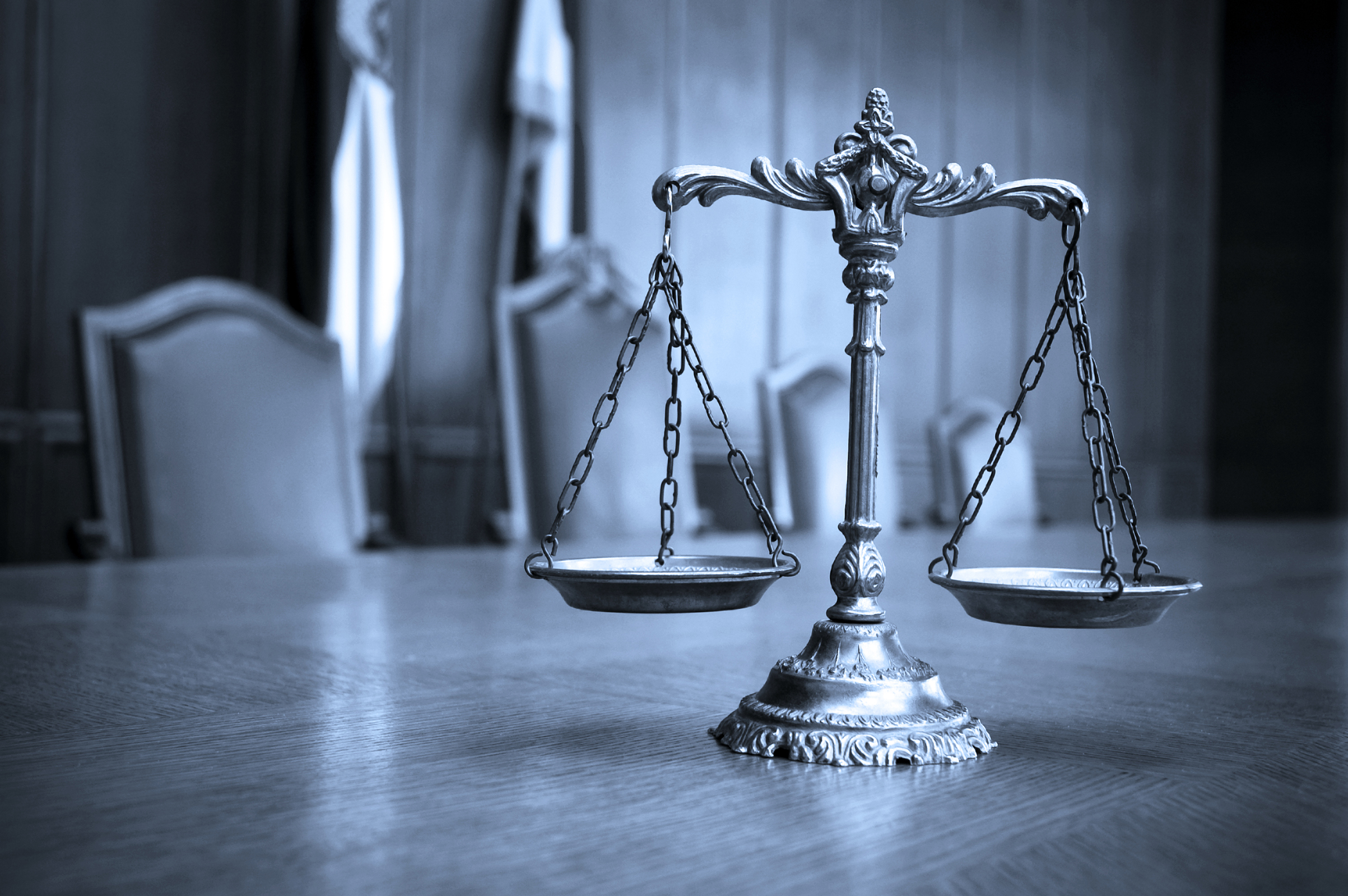 Symbol of law and justice, law and justice concept, focus on the scales, blue tone