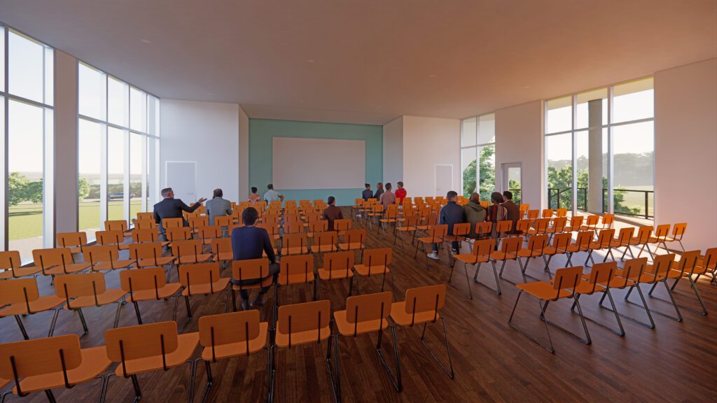 A rendering of the multipurpose room showing seats set in theater style with large windows on the left and right sides of the room.