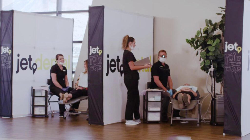 Jet Dental staff with dental chairs separated by partitions