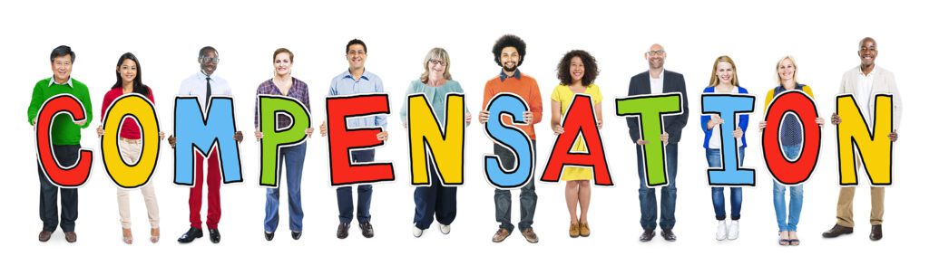 Group of people standing holding letters that spell out compensation