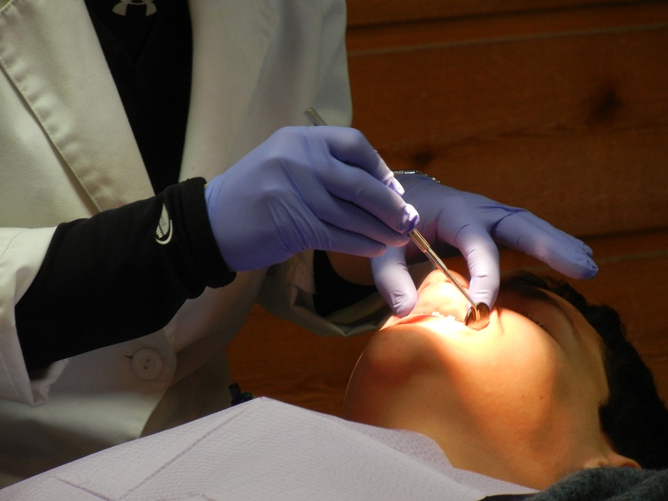 Image of dentist performing a dental exam
