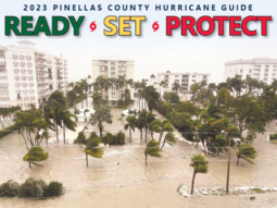 Graphic of the 2023 Hurricane Guide in English. The photo on the cover of the guide shows storm surge covering roads and properties and trees blowing in the wind.