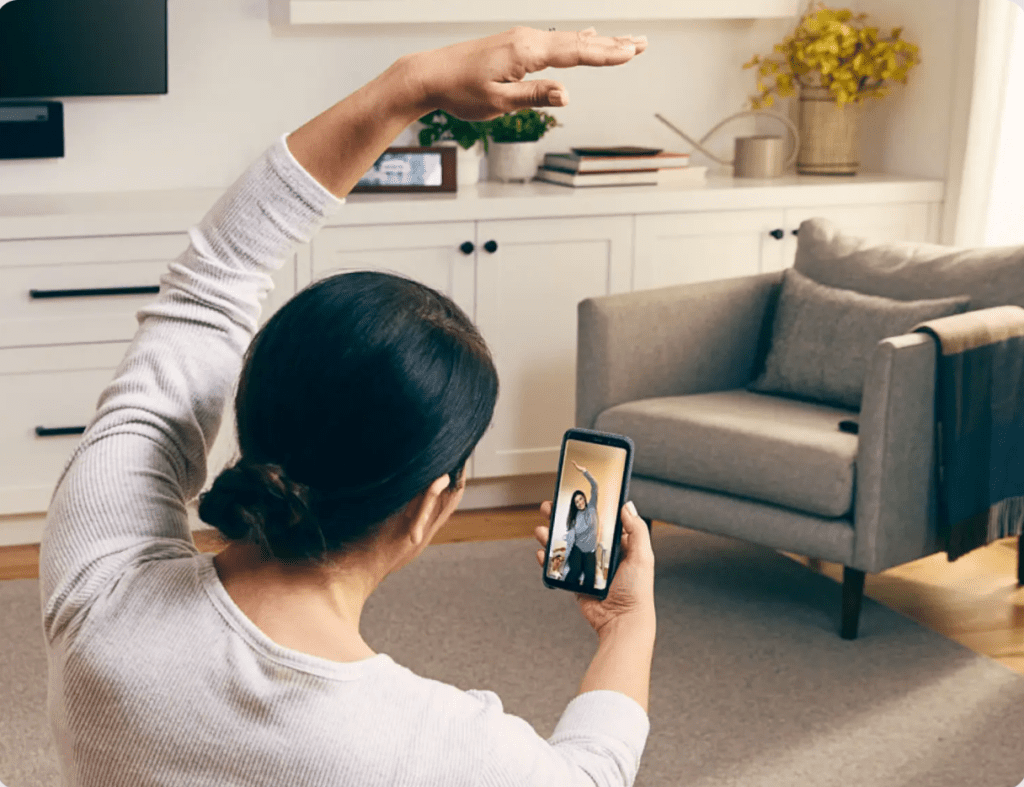 Hinge Health woman exercising while talking with her physical therapist virtually