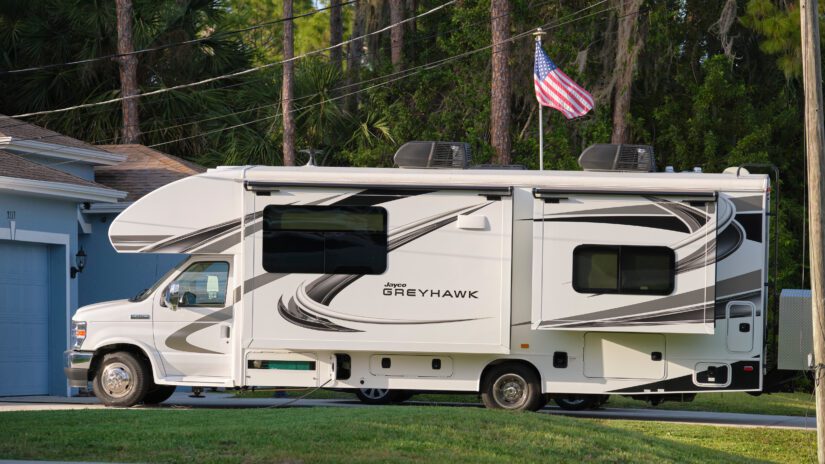 Modern americal motor home van parked in front of a house. USA travel concept. Tampa, Florida, USA - June 3, 2022.