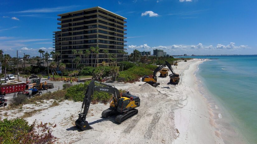 Photograph of heavy earth moving equipment on Sunset Beach bringing in sand and rebuilding sand dunes.