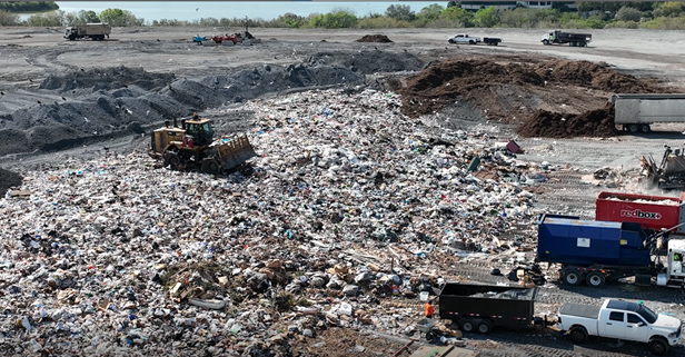 Aerial image of Bridgeway Acres Landfill, showing piled garbage and trucks with trailers dropping off trash.