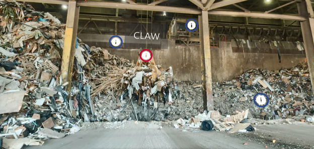 Screenshot of the Waste-to-Energy Facility tipping floor, showing piled garbage inside a building with a large metal claw picking up garbage. Four icons with an "i" inside a circle indicate areas to click for more information, images and videos about the facility.