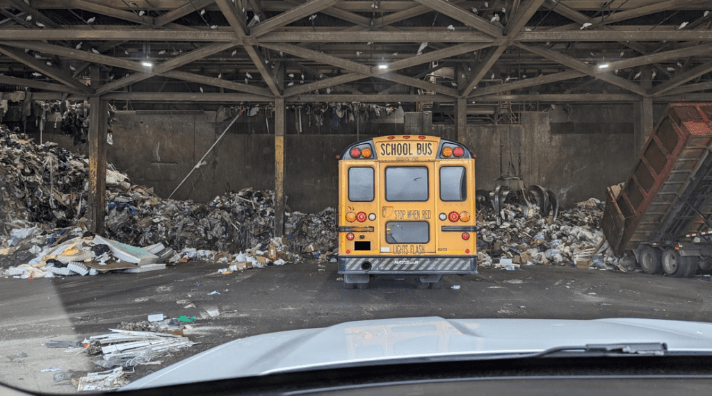 School bus on the Waste-to-Energy Facility tipping floor. 