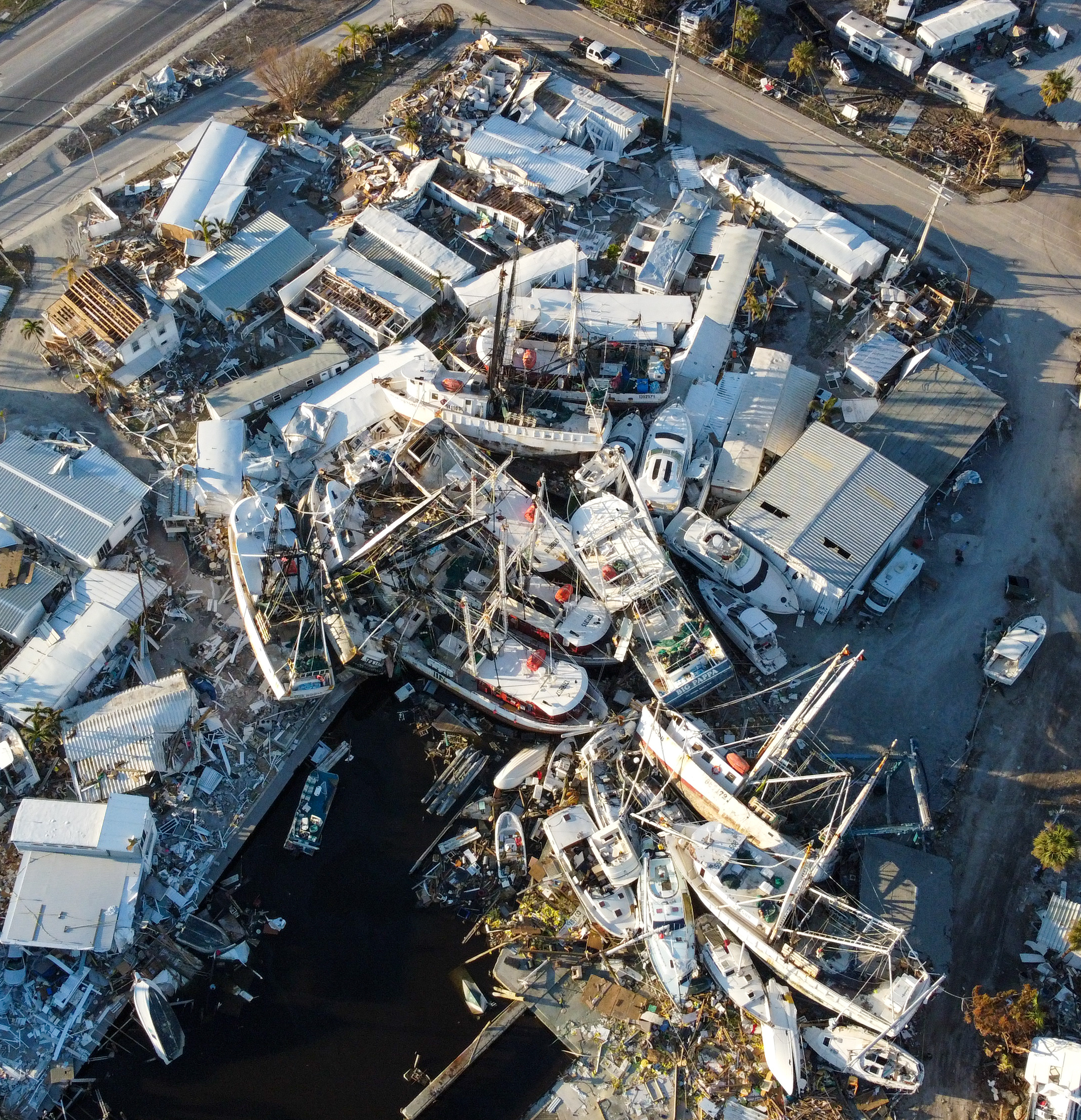 Damaged boats piled along the coastline of Fort Myers after Hurricane Ian