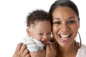 laughing black mother with one month old baby boy