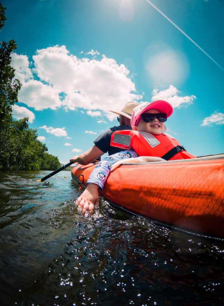 Photo of a child and a man in a canoe