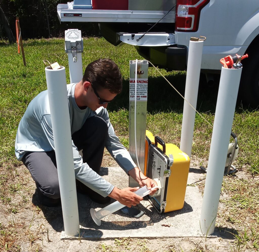 Pinellas County Utilities employee testing the ground water.