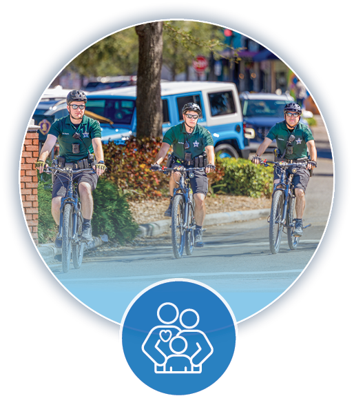 3 police officers patrolling the streets on bikes and a blue health and safe communities icon