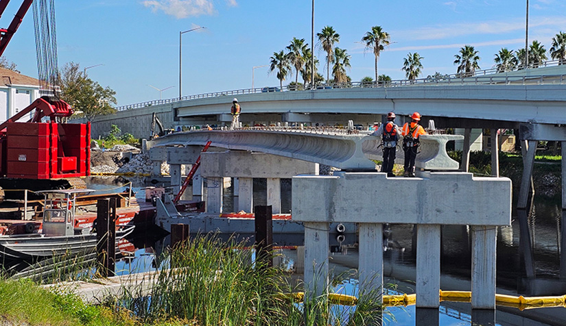 Men in hardhats work on the Tarpon Outfall Canal Pinellas Trail bridge in Oct. 2024