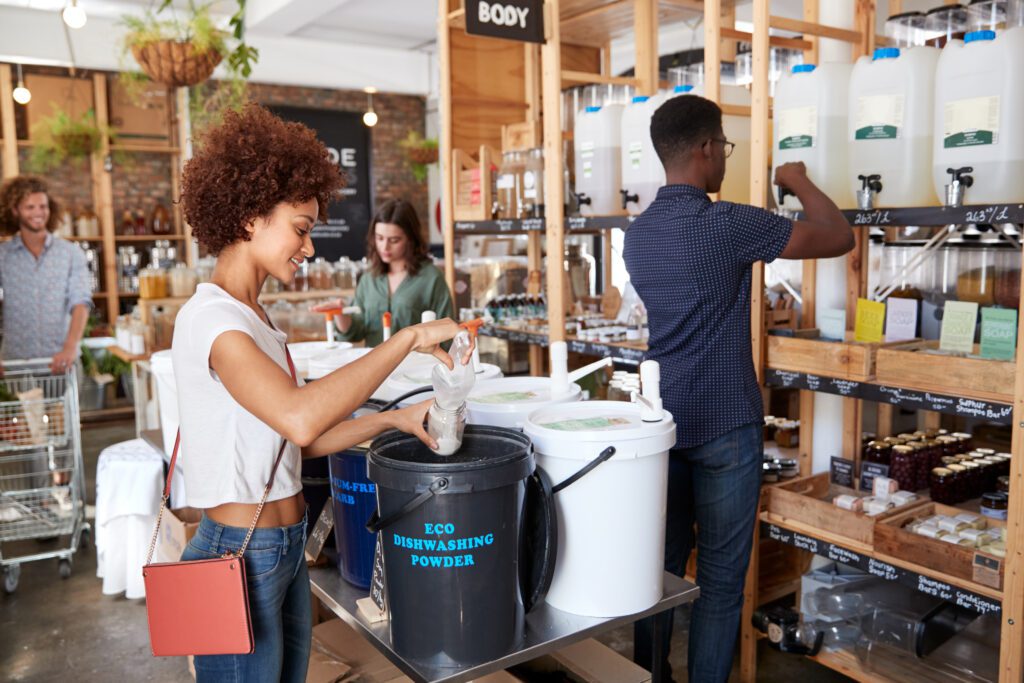 Image of person refilling dishwashing detergent at a refill store.