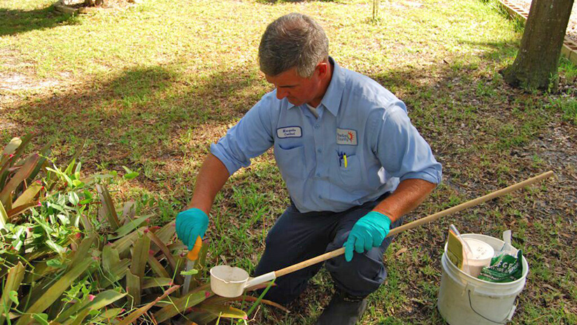 a Pinellas County employee works to control mosquitos