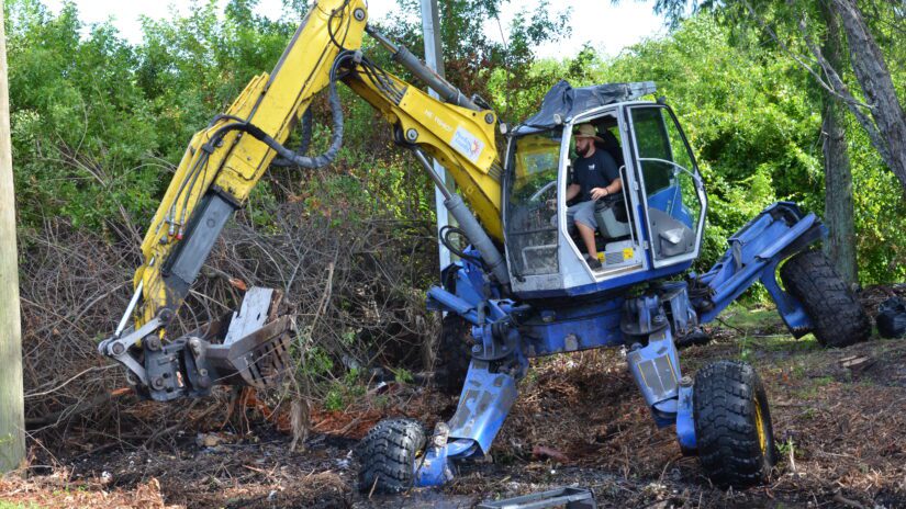 Pinellas County operator using heavy equipment to clear a stormwater ditch