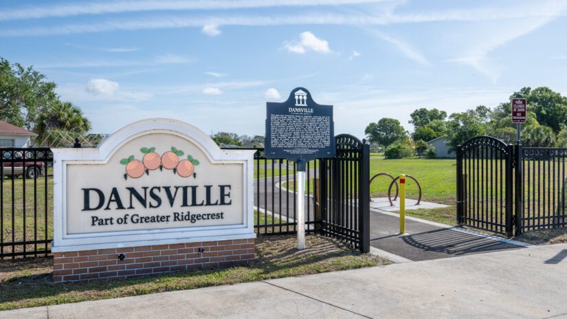 Sign reading Dansville and historical marker at the entrance to Dansville Park