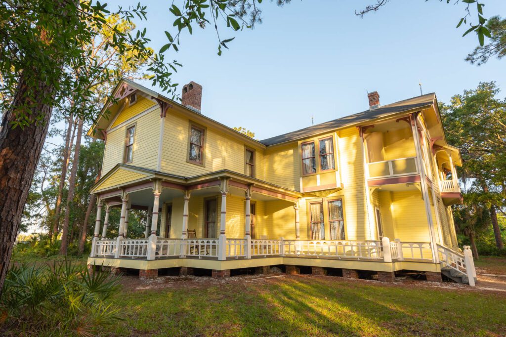 Photo of a yellow, two story house . Originally built in 1907, the house is on display at Heritage Village in Largo, Florida.