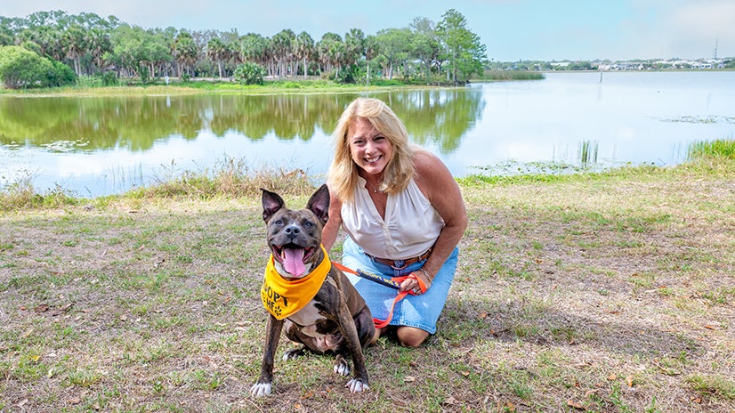 Pinellas County Commissioner Peters posing with adoptable K-9 Michael from Pinellas County Animal Services.