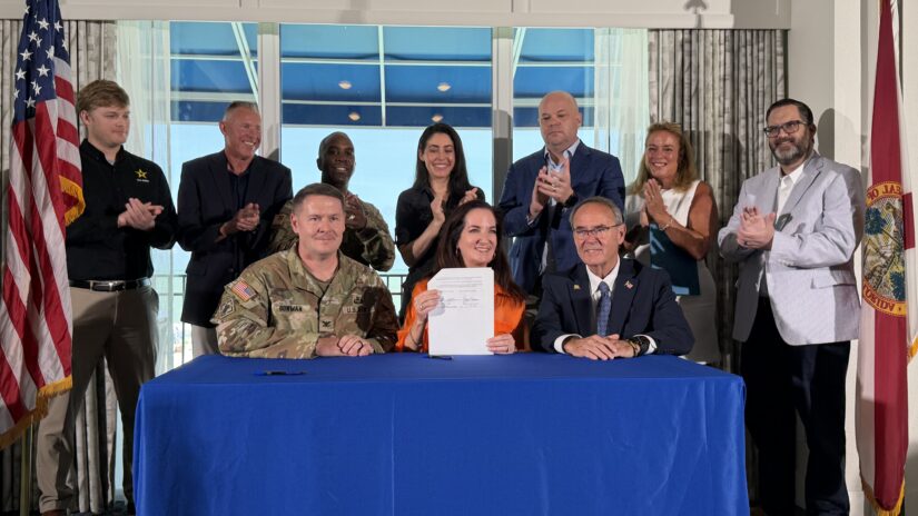 Group photo with signed document